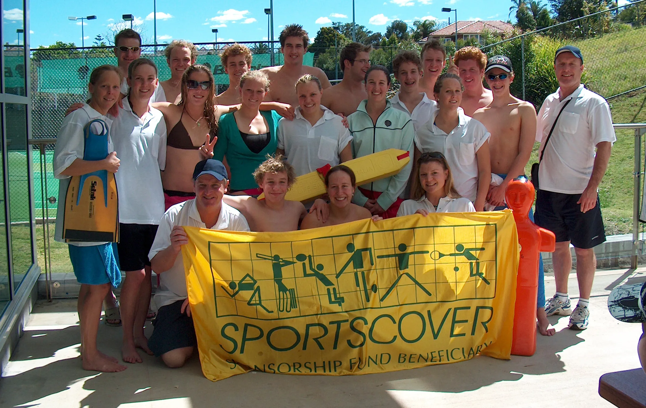 Sports team holding Sportscover Sponsorship banner
