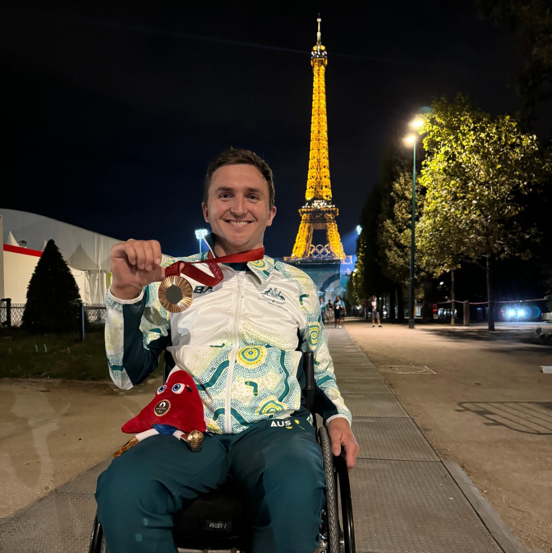 James McQuillan in Paris, with the Eiffel Tower behind him